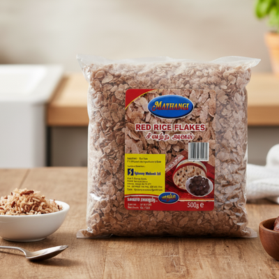 Bag of Methange Red Rice Flakes 500g  on a wooden table with a bowl of rice flakes .